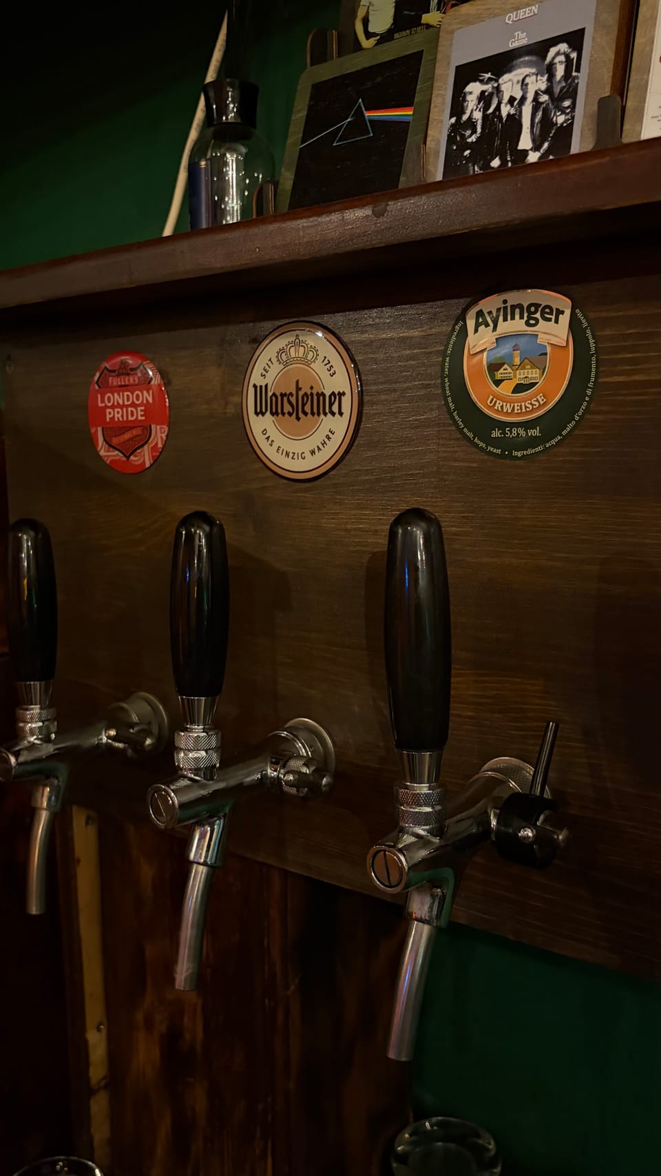 The tap wall at 26 Irish with London Pride, Warsteiner and Ayinger badges