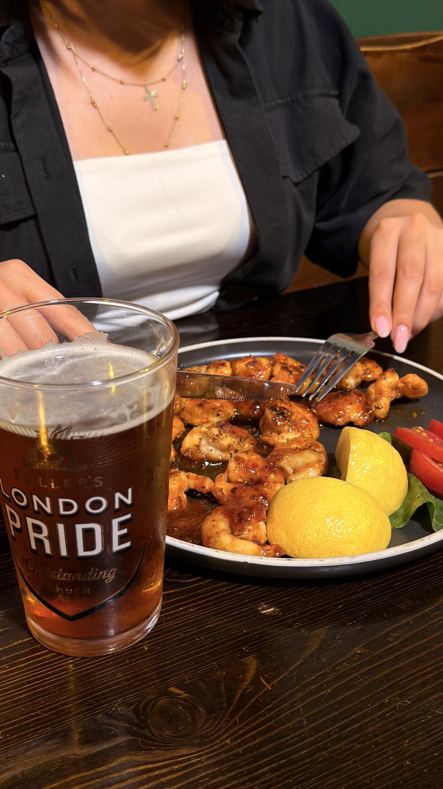 A pint of London Pride and honey-glazed chicken at the table